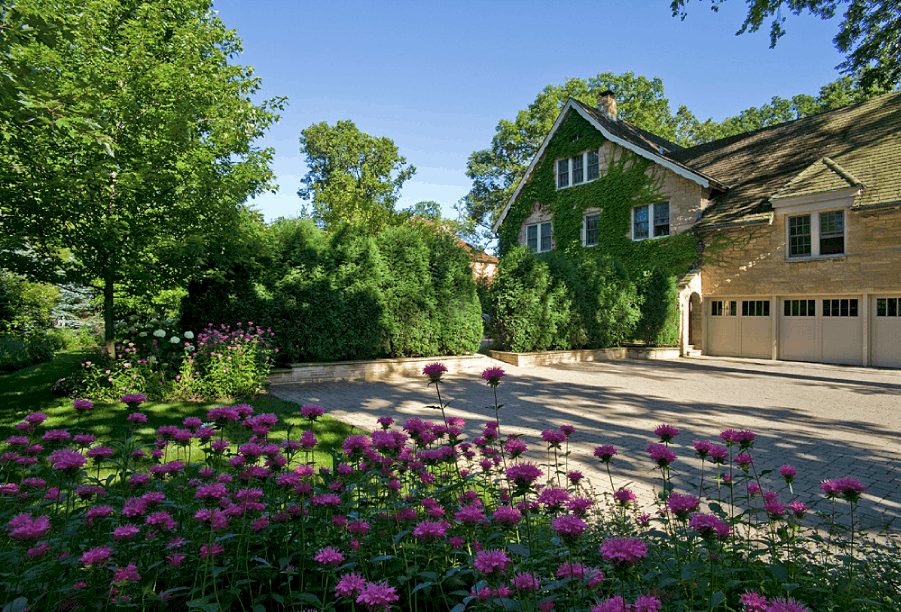 stone paver driveway with purple flowers in the foreground