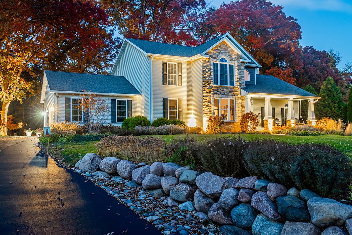 boulder lined driveway with landscape lighting
