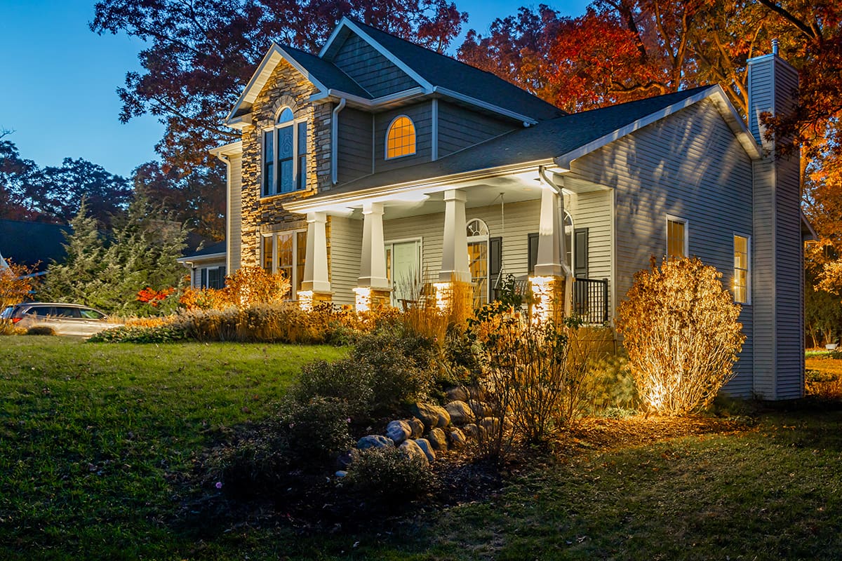 home with landscape lighting at night