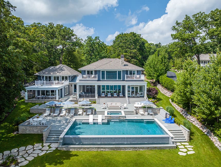 Rear lawn and landscape design with stone pathways and structured planting at a lakeside home in Williams Bay, Wisconsin.